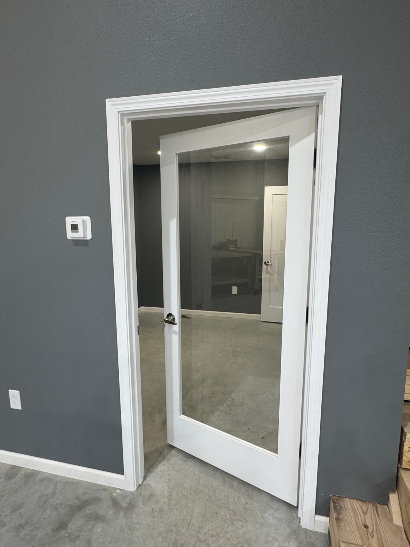 Finished office area with glass entry door inside a suite