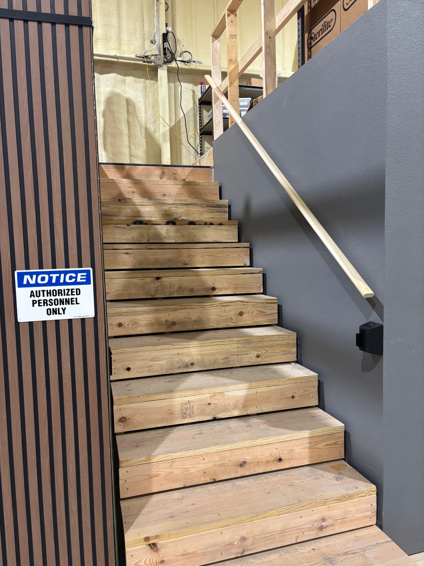 Wood stair run leading to a mezzanine inside a suite